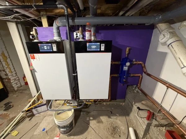 A pair of high-efficiency condensing boilers installed by SOS in a Rhode Island basement