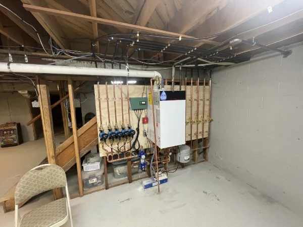 High-efficiency boiler and zone manifold serviced by SOS in a Rhode Island basement