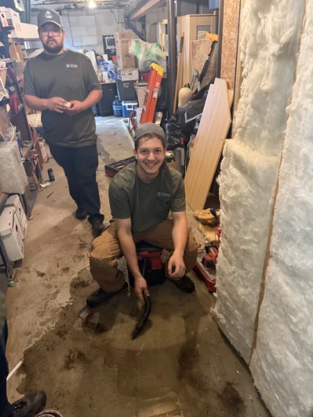SOS technician at work on a plumbing repair in a Rhode Island home