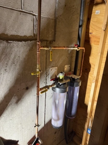 SOS-serviced whole-house water filter and pressure tank in a Rhode Island home