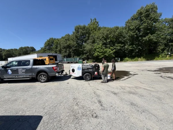 SOS service truck and trailer-mounted hydro jetter on a Rhode Island job site