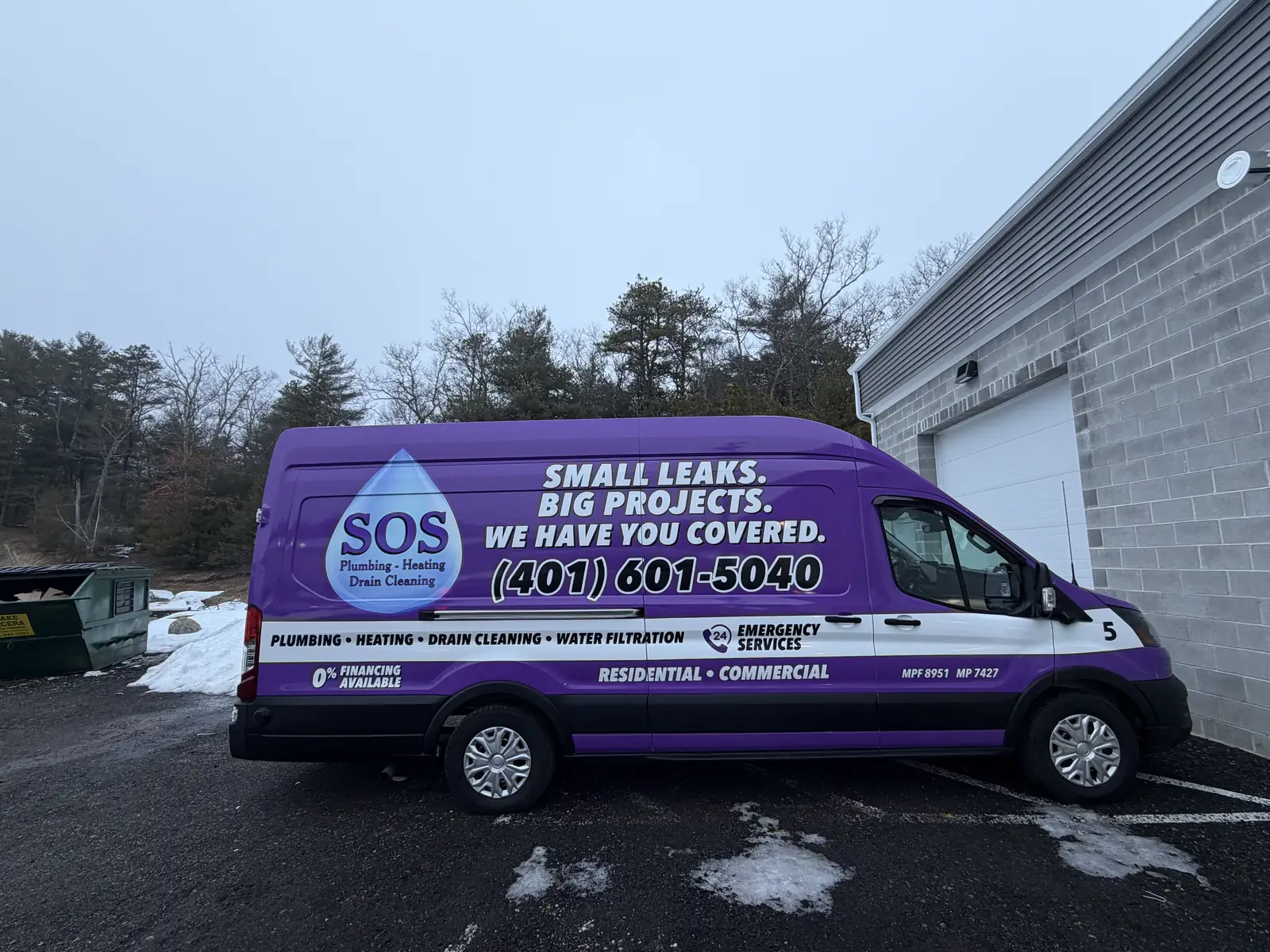 Branded SOS Plumbing & Heating service van outside the West Warwick shop