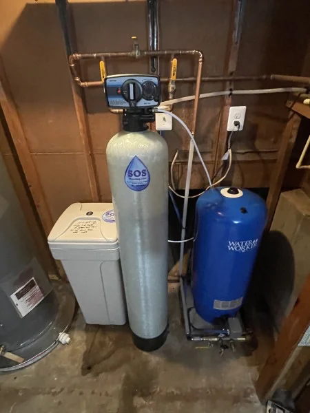 Whole-home water filtration tank and pressure tank installed by SOS in a Rhode Island basement